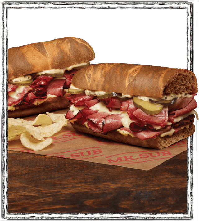 marble rye double stack sandwich on table with chips